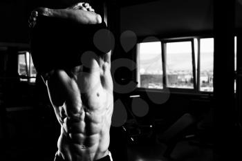 Attractive Bodybuilder Taking His Shirt Off After Training In A Gym