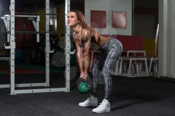 Fitness Woman Working Out With Kettle Bell