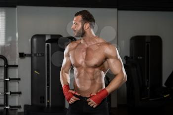 Portrait Of A Physically Fit Man Posing In Modern Fitness Center Gym