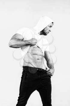 Portrait Of A Young Physically Fit Man Showing His Well Trained Body On Yellow Background - Muscular Athletic Bodybuilder Fitness Model Posing After Exercises