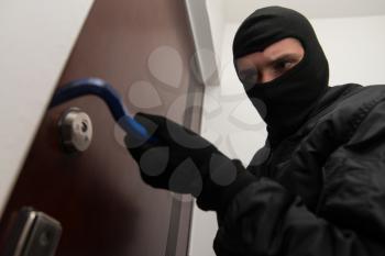 Thief Burglar Force Lock Metal Door With A Tool During House Breaking