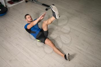 Personal Trainer Performing Abdominal Exercise On Floor - One Of The Most Effective Ab Exercises