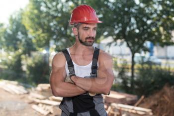 Portrait Of Handsome Male Architect Engineer With Red Helmet