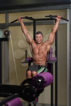 Young Healthy Man Exercising Abdominals In Gym