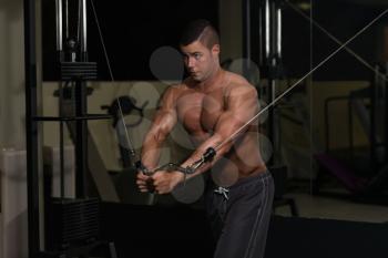 Young Man Is Working On His Chest With Cable Crossover In A Modern Fitness Gym