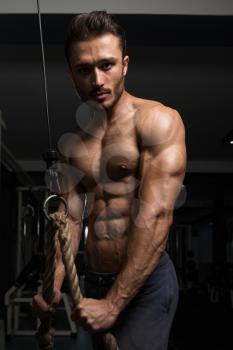 Handsome Muscular Fitness Bodybuilder Doing Heavy Weight Exercise For Triceps In The Gym