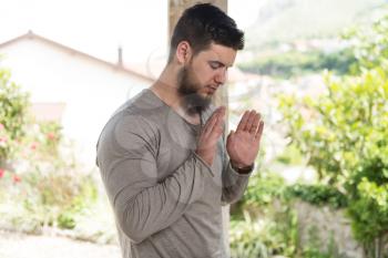 Muslim Man Is Praying In The Mosque Outdoors