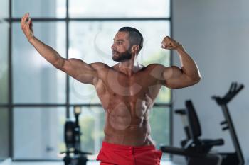 Portrait Of A Young Physically Fit Man Showing His Well Trained Body - Muscular Latin Athletic Bodybuilder Fitness Model Posing After Exercises