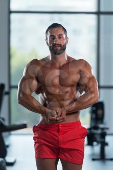 Portrait Of A Young Physically Fit Man Showing His Well Trained Body - Muscular Latin Athletic Bodybuilder Fitness Model Posing After Exercises