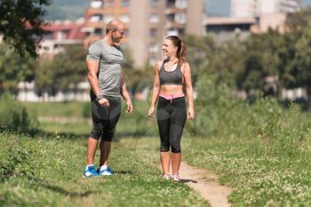 Portrait Of A Young Physically Fit Couple Showing Their Well Trained Body Resting After Running - Muscular Athletic Bodybuilder Fitness Model Posing After Exercises