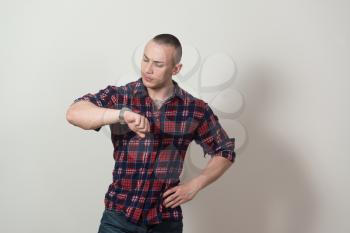 Portrait of a Successful Young Man Standing Isolated on Grey Background