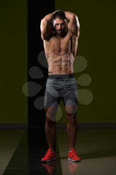 Portrait Of A Young Physically Fit Man Showing His Well Trained Body - Muscular Athletic Bodybuilder Fitness Model Posing After Exercises