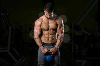 Healthy Man Exercising With Kettle Bell And Flexing Muscles - Muscular Athletic Bodybuilder Fitness Model Exercises