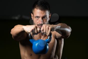 Healthy Man Exercising With Kettle Bell And Flexing Muscles - Muscular Athletic Bodybuilder Fitness Model Exercises