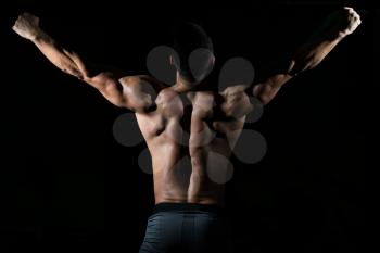 Handsome Man Standing Strong In The Gym And Flexing Muscles - Muscular Athletic Bodybuilder Fitness Model Posing After Exercises