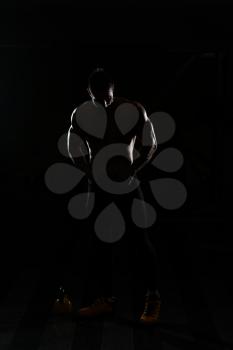 Silhouette Portrait Of A Young Physically Fit Man Showing His Well Trained Body - Muscular Athletic Bodybuilder Fitness Model Posing After Exercises