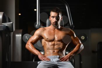 Resting Time - Confident Muscled Young Man Resting In Healthy Club Gym After Exercising