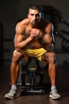 Resting Time - Confident Muscled Young Man Resting In Healthy Club Gym After Exercising