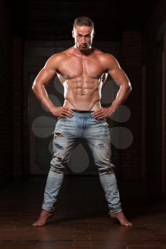 Portrait Of A Young Physically Fit Man In Jeans Showing His Well Trained Body - Muscular Athletic Bodybuilder Fitness Model Posing After Exercises