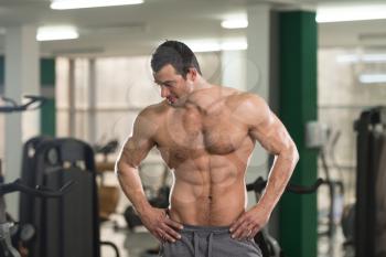 Portrait Of A Young Physically Fit Hairy Man Showing His Well Trained Body - Muscular Athletic Bodybuilder Fitness Model Posing After Exercises