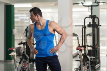 Portrait Of A Young Physically Fit Man In Blue Undershirt Showing His Well Trained Body - Muscular Athletic Bodybuilder Fitness Model Posing After Exercises