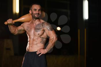 Young Man Exercising With Bowling Pin And Flexing Muscles - Muscular Athletic Bodybuilder Fitness Model Exercises