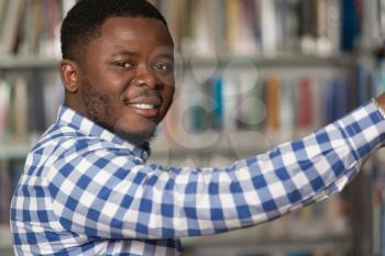 Portrait Of A College Student Man In Library - Shallow Depth Of Field