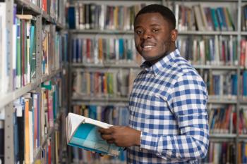 Portrait Of A College Student Man In Library - Shallow Depth Of Field