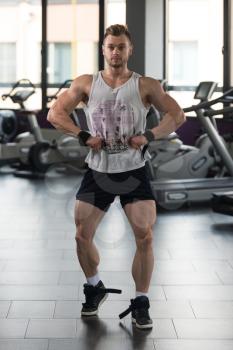 Portrait Of A Young Physically Fit Man In Undershirt Showing His Well Trained Body - Muscular Athletic Bodybuilder Fitness Model Posing After Exercises
