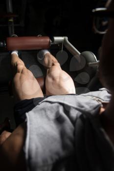 Leg Exercises Close Up -  Man Doing Leg With Machine In Gym