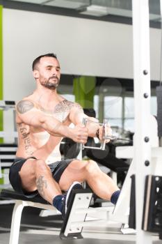 Handsome Bodybuilder Doing Heavy Weight Exercise For Back On Machine