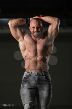 Handsome Young Man Standing Strong In Pants And Flexing Muscles - Muscular Athletic Bodybuilder Fitness Model Posing After Exercises