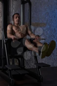 Young Man Performing Hanging Leg Raises Exercise - One Of The Most Effective Ab Exercises