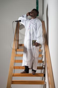 African Muslim Man Making Traditional Prayer To God While Wearing A Traditional Cap Dishdasha