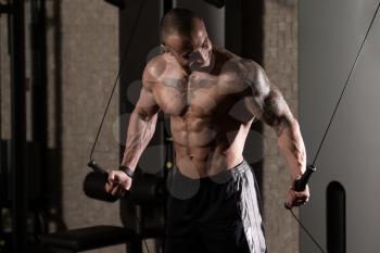 Man Is Working On His Chest With Cable Crossover In A Modern Gym