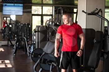 Portrait Of A Muscular Man In Shorts And Red T-shirt Posing