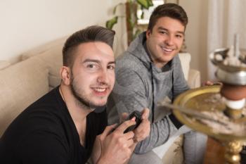 Two Men Competitive Friends Playing Video Games and Excited Happy Cheerful at Home