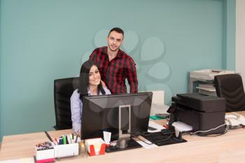 Happy Young Business Man And Woman Work In Modern Office On Computer