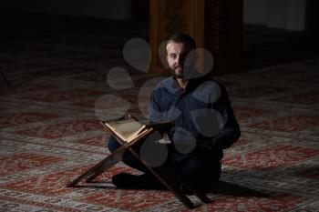 Adult Muslim Man Is Reading The Koran In The Mosque