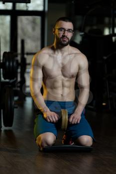 Young Man Wearing Glasses Exercising Fitness Workout For Abdominal With Toning Wheel