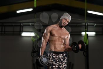 Man Working Out Biceps In A Dark Gym - Dumbbell Concentration Curls