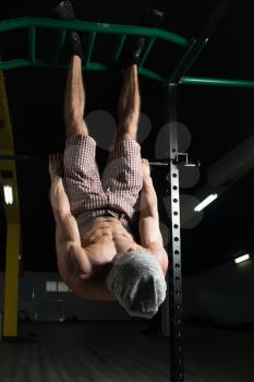 Man Performing Hanging Leg Raises Exercise - One Of The Most Effective Ab Exercises