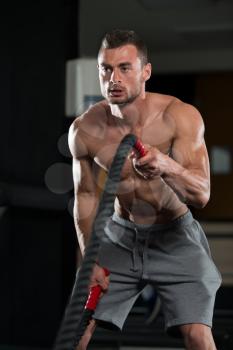 Battling Ropes Young Man At Gym Workout Exercise