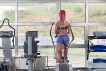Fitness Girl Exercising On Moonwalker Treadmill In A Modern Fitness Center