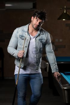 Portrait Of A Young Man Concentration On Ball In Pool Game Billiard