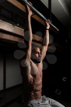 Model Performing Hanging Leg Raises Exercise - One Of The Most Effective Ab Exercises
