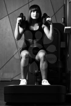 Woman Working Out Legs On Machine In A Gym - Leg Exercise