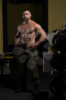 Portrait Of A Young Physically Fit Man Showing His Well Trained Body In Army Pants - Muscular Athletic Bodybuilder Fitness Model Posing After Exercises