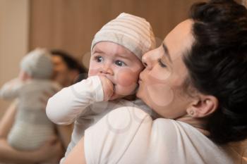 Happy Mother with Child Baby Boy at Home in the Living Room Playing and Laughing