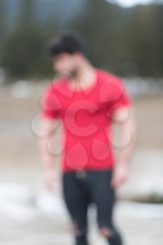 Portrait of Handsome Man Dressed in Fashionable Clothes Standing in Nature Background With Area for Advertising Content - Hipster Guy Posing on Copy Space - Picture is Blurred